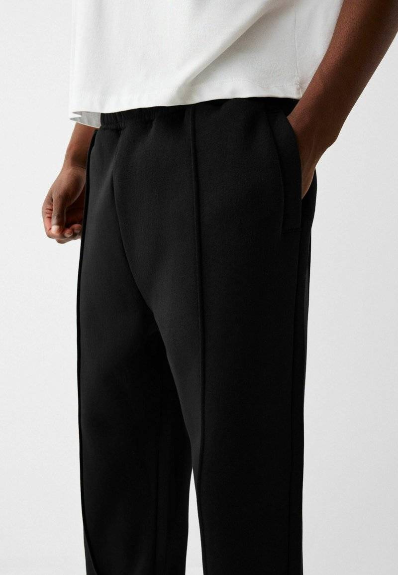 Bershka Bershka WIDE - Tracksuit bottoms - black Schlussverkauf