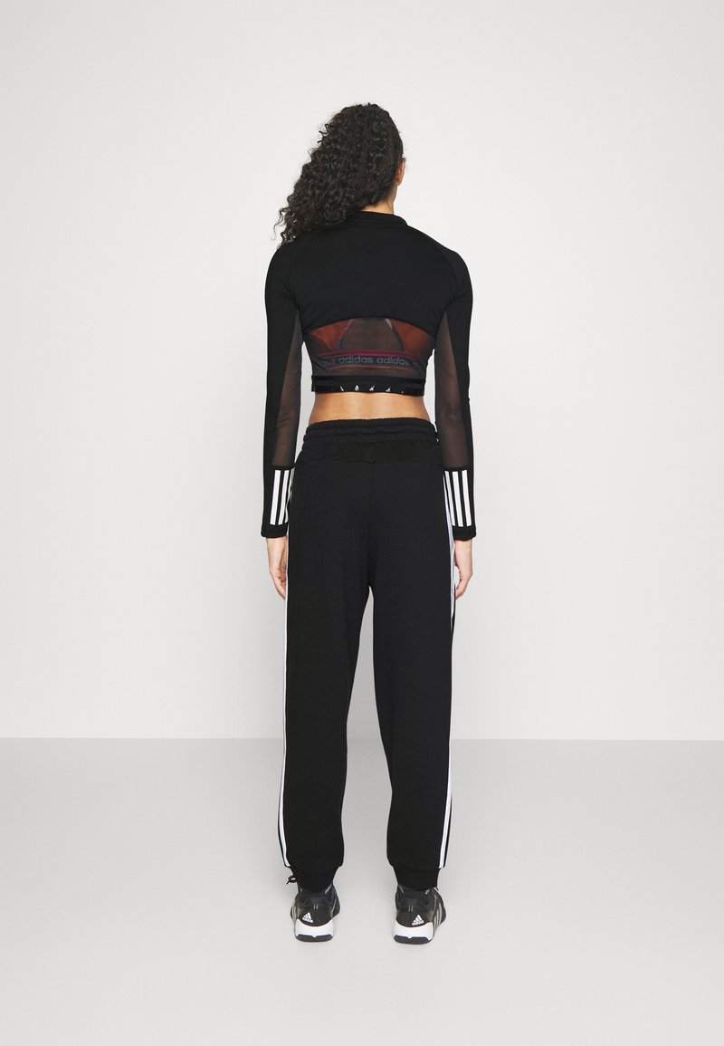 adidas Sportswear adidas Sportswear ESSENTIALS 3-STRIPES LOOSE-FIT - Tracksuit bottoms Cyber Monday