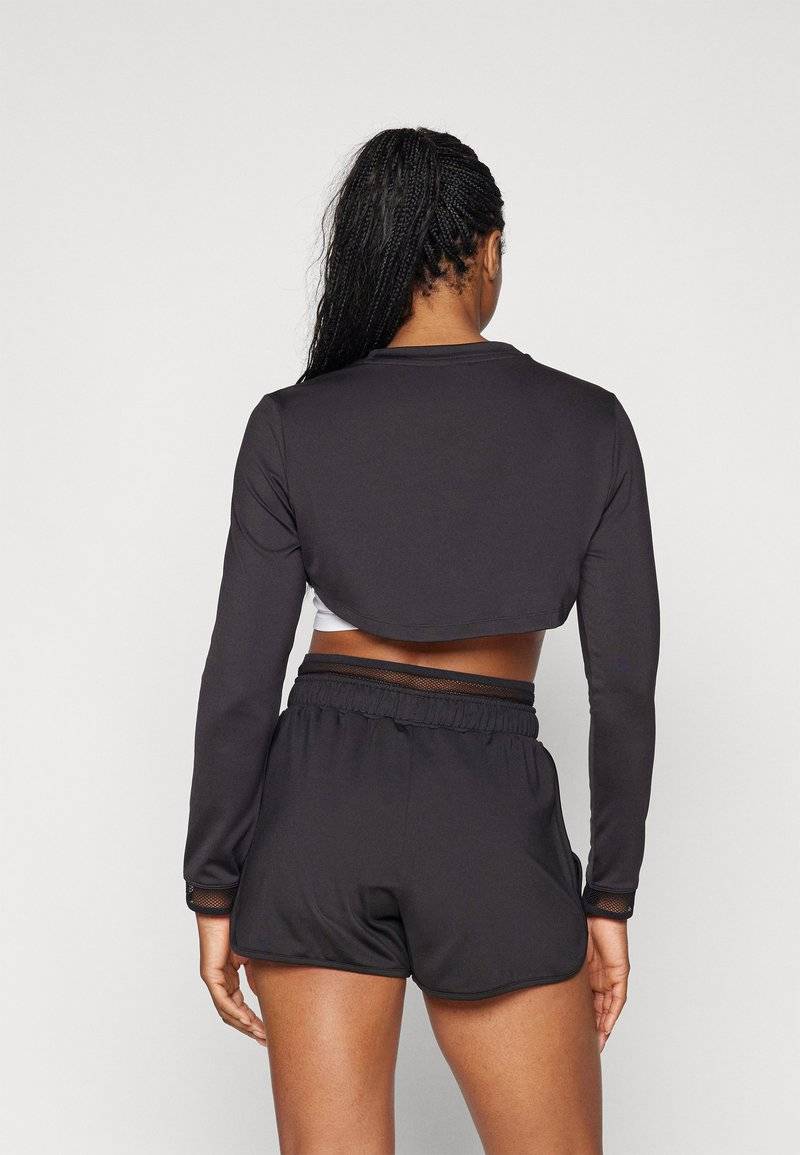 Puma Puma PAMELA REIF CROPPED - Long sleeved top - black Günstiger Verkauf