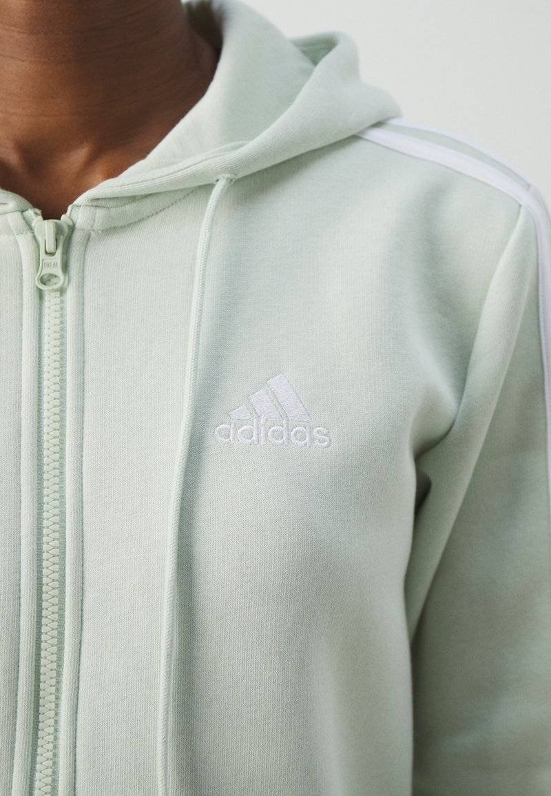 adidas Sportswear adidas Sportswear ESSENTIALS 3 STRIPES FULL ZIP HOODIE - Zip-up sweatshirt - linen green Wochenangebot