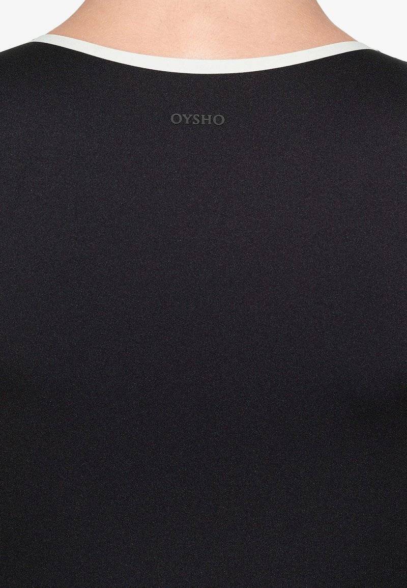 OYSHO OYSHO PERFECT-ADAPT PIPING - Sports T-shirt - black Bestseller