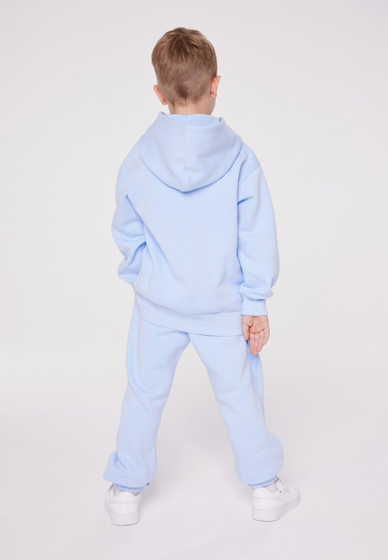 Champion Champion EXCLUSIVE PANT UNISEX - Tracksuit bottoms - light blue Saisonale Angebote