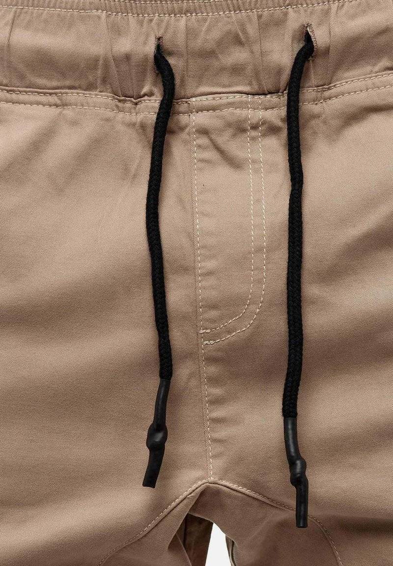 Tazzio Tazzio Cargo trousers - beige 50% Rabatt mit kostenlosem Versand